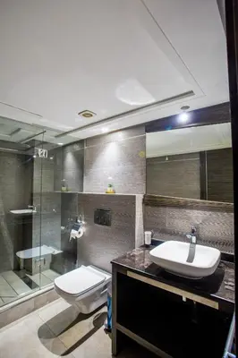 a bathroom with a sink and a toilet and a shower at Top flat at central Massira Maarif in Casablanca