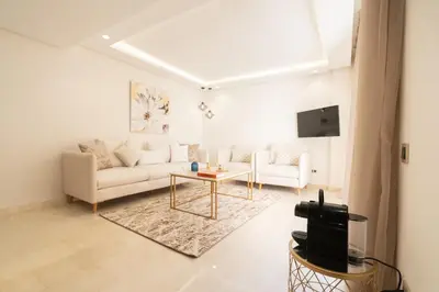 a living room with a couch and a table at Fresh maarif flat in new building in Casablanca
