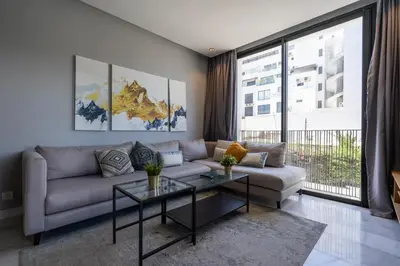 a living room with a couch and a table at c4 .super appartement with parking in Casablanca