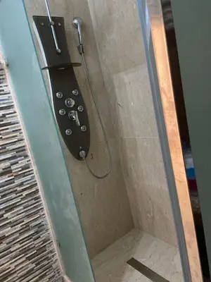 a shower with a shower head in a bathroom at Apparemment à mohammadia in Mohammedia
