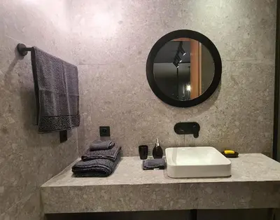 a bathroom with a sink and a mirror and towels at Superbe studio avec une belle terrasse à Gauthier in Casablanca