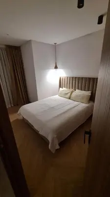 a bedroom with a white bed with a light on it at Superbe studio avec une belle terrasse à Gauthier in Casablanca
