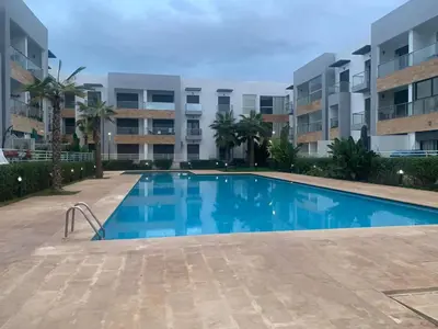 a swimming pool in front of a apartment building at Ocean Palm Aρραrt Pοοl Vieω in Casablanca