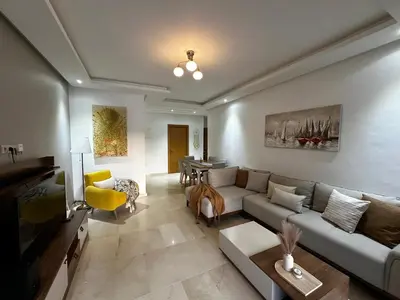 a living room with a couch and a table at Ocean Palm Aρραrt Pοοl Vieω in Casablanca