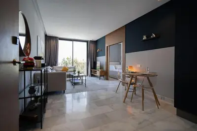 a living room with a table and a couch at super appartement with parking c4 in Casablanca