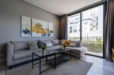 a living room with a couch and a table at super appartement with parking c4 in Casablanca