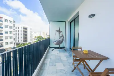 a balcony with a wooden table and a swing at Amazing view Fast WiF with Gym near tramway in Casablanca