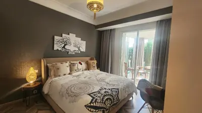 a bedroom with a bed and a window at Magnifique appartement Casa Finance City in Casablanca