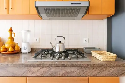 a kitchen stove with a tea kettle on it at Layover Guest House Apartment & parking Rabat Agdal City Center in Rabat