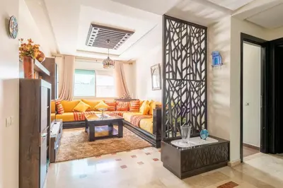 a living room with a couch and a table at Layover Guest House Apartment & parking Rabat Agdal City Center in Rabat
