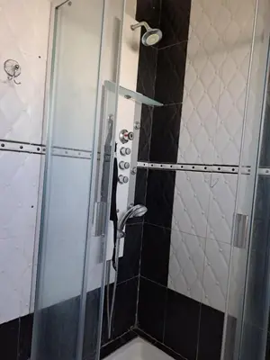 a shower with a glass door in a bathroom at Villa de rêves in Casablanca