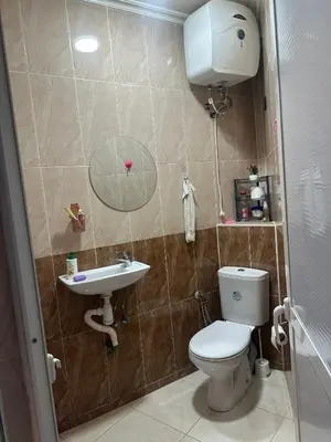 a bathroom with a toilet and a sink at Garden Beet in Sidi Rahal