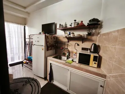 a kitchen with a white refrigerator and a microwave at Garden Beet in Sidi Rahal