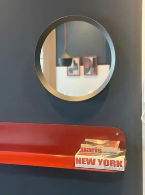 a mirror above a red shelf with a stack of books at Upscale flat with Gym in Casablanca