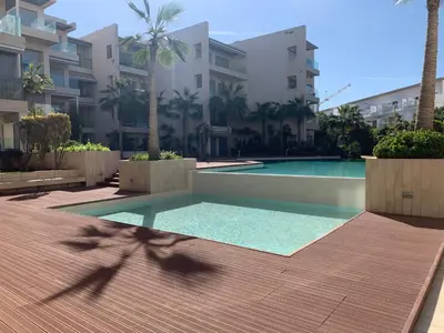 a swimming pool in front of a building at Appartement de standing vue sur mer à Mohammedia in Mohammedia