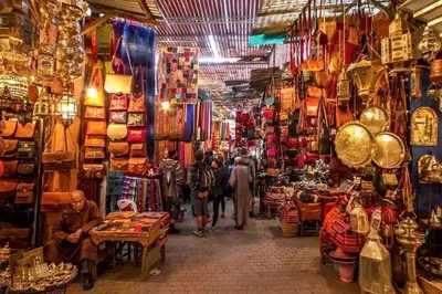 a group of people walking through a shop in a market at Appartement de standing vue sur mer à Mohammedia in Mohammedia
