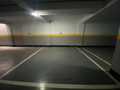 an empty parking garage with a yellow stripe on the wall at CORNICHE CASABLANCA - SUBLIME F2 NEUF in Casablanca