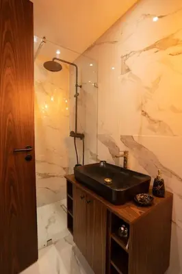 a bathroom with a black sink and a shower at Luxury one bedroom in Maarif one in Casablanca