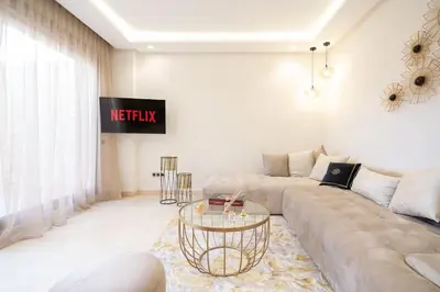 a living room with a couch and a glass table at Luxury one bedroom in Maarif one in Casablanca