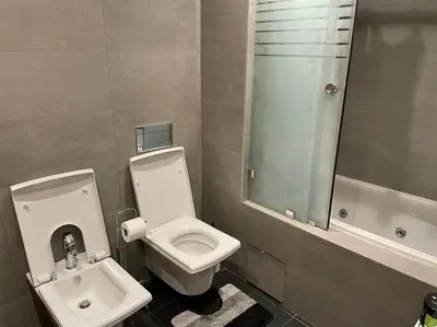 a bathroom with a toilet and a sink at Superb Apartment on 14th floor with Jacuzzi in Casablanca