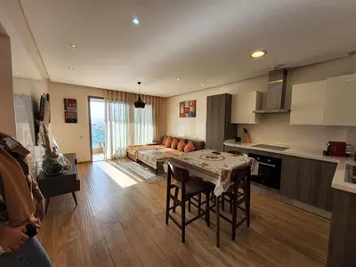 a kitchen with a table and a couch in a room at Superb Apartment on 14th floor with Jacuzzi in Casablanca