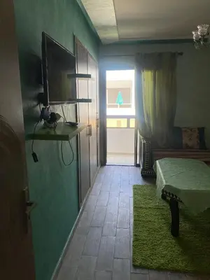 a room with a bedroom with a bed and a window at Mohammédia Marbella beach appartement familliale in Mansouria