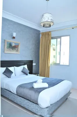 a bedroom with a large bed and a window at EAST WEST HOTEL in Casablanca