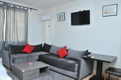 a living room with a couch and a flat screen tv at EAST WEST HOTEL in Casablanca
