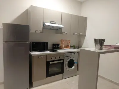 a kitchen with a refrigerator and a washing machine at Chez Betty in Casablanca
