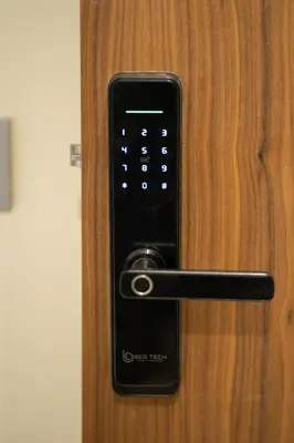 a black remote control on a wooden door at Chez Betty in Casablanca