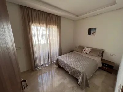 a bedroom with a bed and a large window at TAJ NOUACEUR AéROPORT MOHAMMED V in Nouaceur