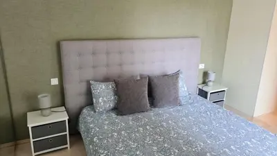 a bedroom with a large bed with two night stands at Duplex Rooftop d'exception terrasse panoramique de 100 m2 in Casablanca