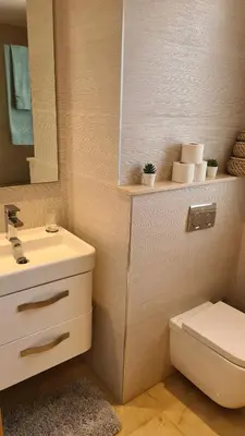 a bathroom with a sink and a toilet and a mirror at Duplex Rooftop d'exception terrasse panoramique de 100 m2 in Casablanca