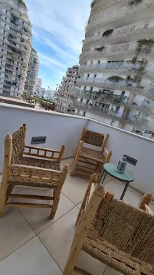 a balcony with chairs and a table and buildings at Duplex Rooftop d'exception terrasse panoramique de 100 m2 in Casablanca