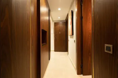 a hallway with wooden walls and a long hallway with at New upscale central maarif flat in Casablanca