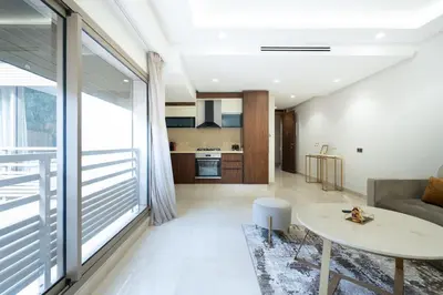 a living room with a couch and a table at New upscale central maarif flat in Casablanca
