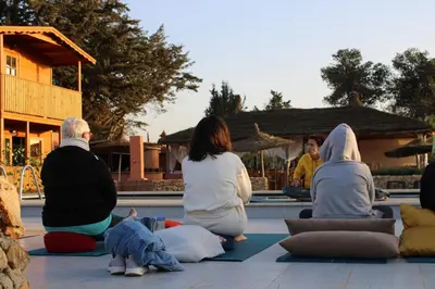 a group of people sitting on the ground in meditation at Ferme Sacrée Nature in O Ben Slimane