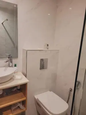 a white bathroom with a toilet and a sink at Luxury in the heart of Hay Riad in Rabat