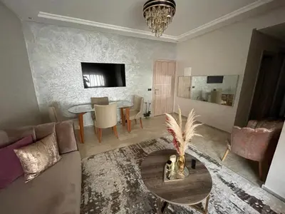 a living room with a couch and a table at Superbe Appartement Bouskoura in Bouskoura