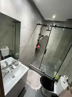 a bathroom with a shower and a toilet and a sink at Superbe Appartement Bouskoura in Bouskoura