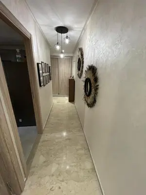 a hallway with paintings on the walls of a room at Superbe Appartement Bouskoura in Bouskoura