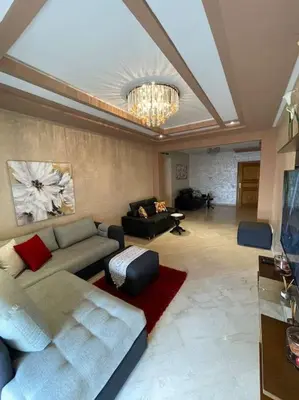 a living room with a couch and a chandelier at Big luxury apartment near airport in Nouaceur