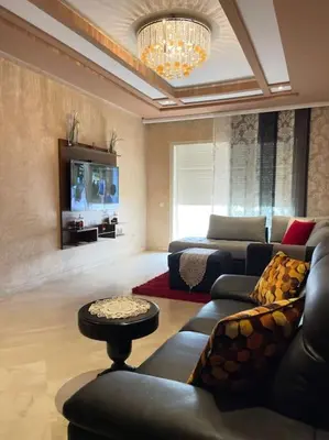 a living room with a couch and a tv at Big luxury apartment near airport in Nouaceur