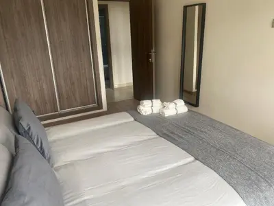 a bedroom with a bed with towels on it at Luxueux appartement avec vue panoramique WELCOME STAY in Mohammedia