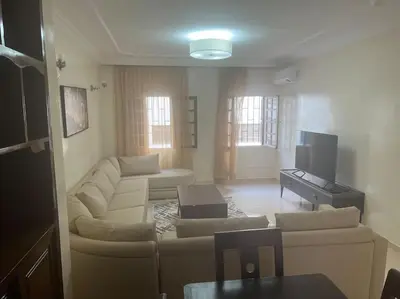 a living room with a couch and a tv at Au centre de Agdal in Rabat