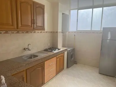 a small kitchen with a sink and a refrigerator at Au centre de Agdal in Rabat