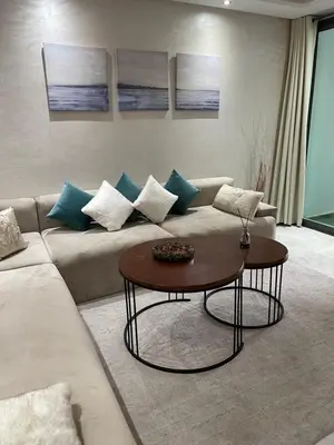a living room with a couch and a coffee table at Miramare Cosy appartement pied dans l'eau avec piscine in Mohammedia