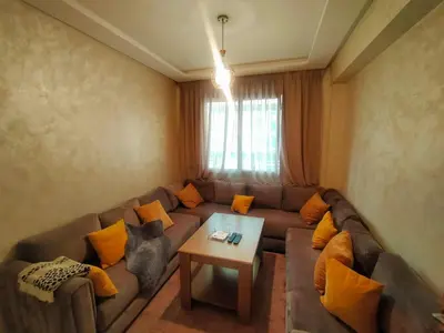 a living room with a couch and a table at 3 Bedroom Apartment with Wifi in Casablanca
