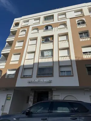 a building with a car parked in front of it at Appt front la mer in Rabat
