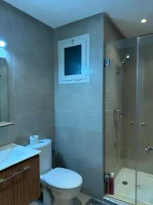 a bathroom with a toilet and a shower and a sink at Appt front la mer in Rabat